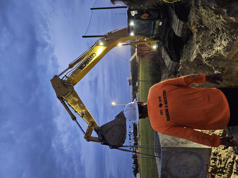 Diamond 8 Kobelco excavator setting drain box — night work